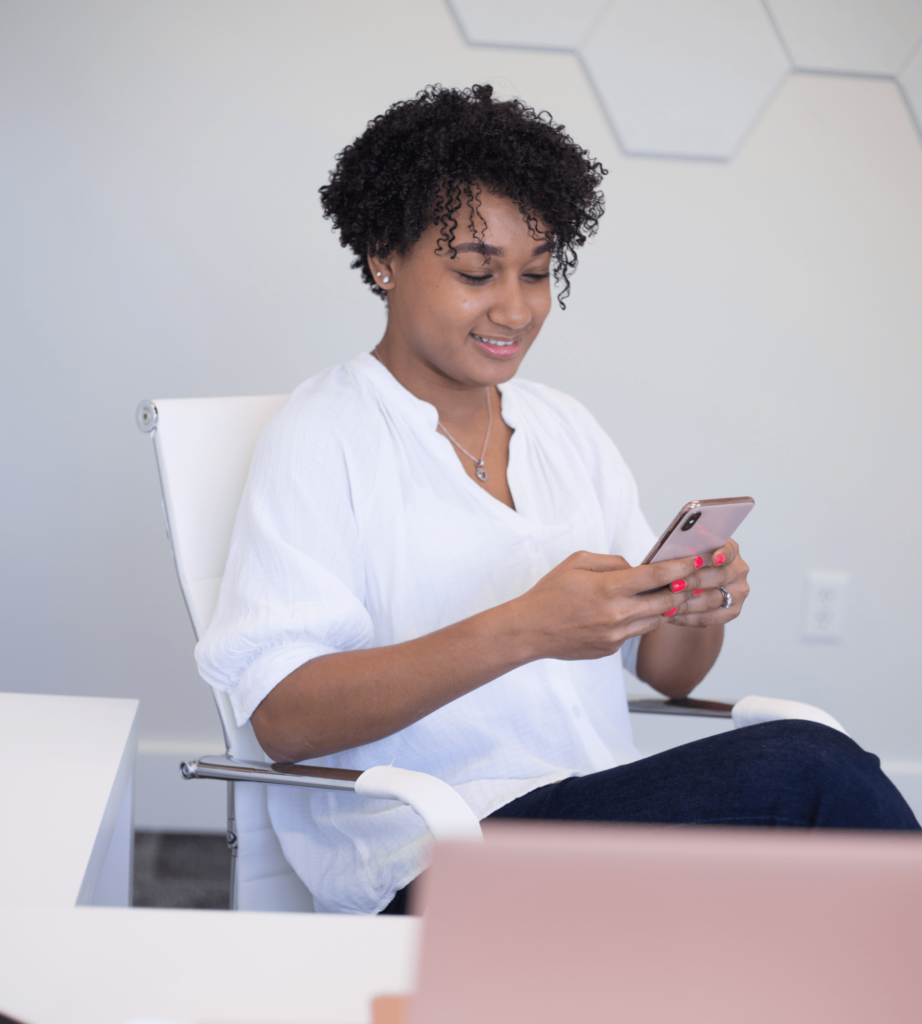 Portrait of Emma Carter smiling while looking at her phone, team member photo in the Layout 3 team section demo
