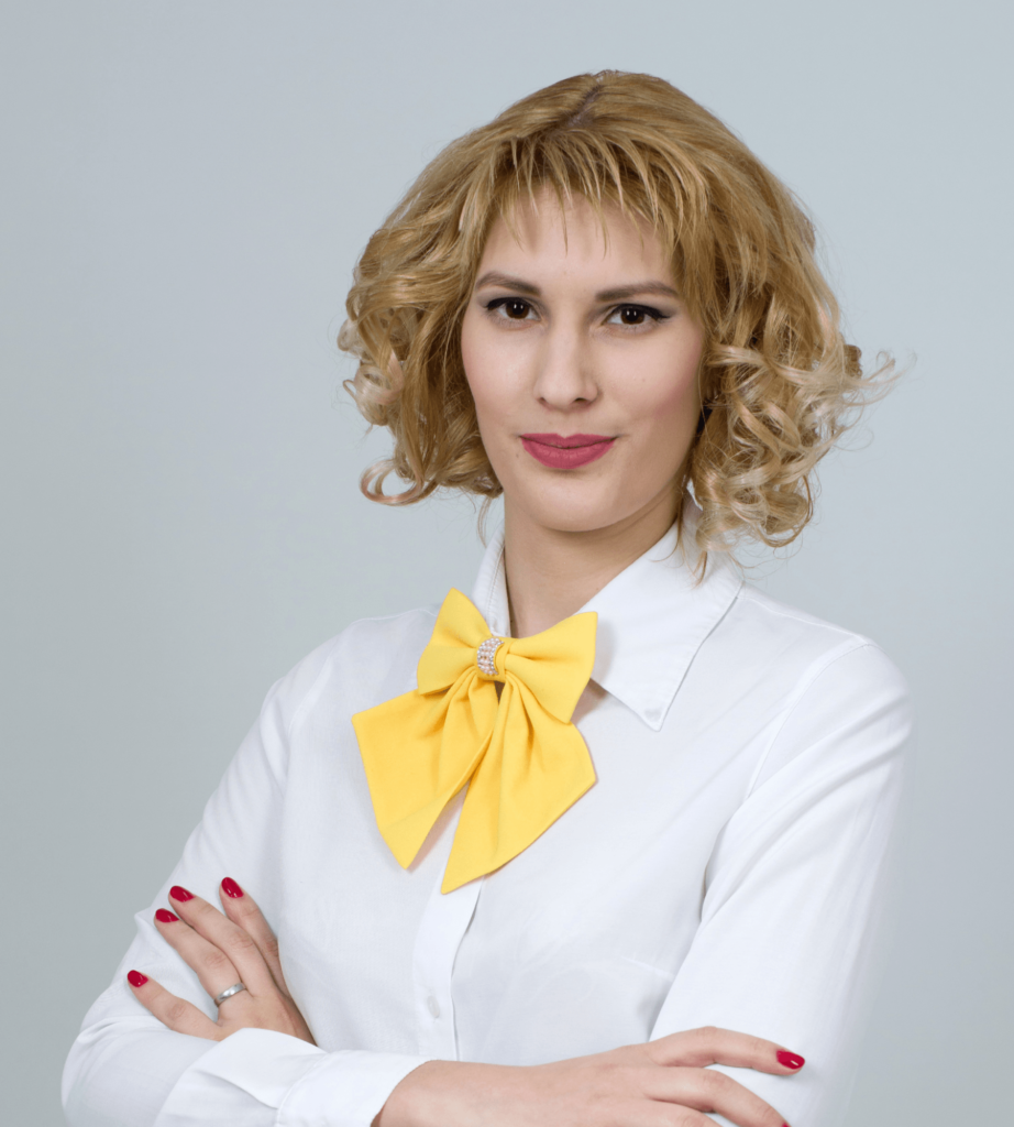 Portrait of Sophia Reed in a white blouse with a yellow bow tie, team member photo in the Layout 3 team section demo